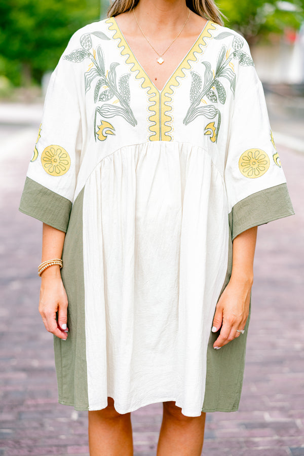 Chic Soul plus size clothing, white dress with half sleeves and olive accents on the ends of the sleeves and sides of the dress as well as a floral abstract pattern on the chest area and sleeves 