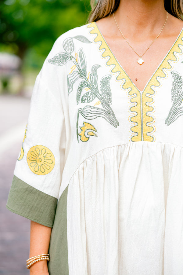 Chic Soul plus size clothing, white dress with half sleeves and olive accents on the ends of the sleeves and sides of the dress as well as a floral abstract pattern on the chest area and sleeves 