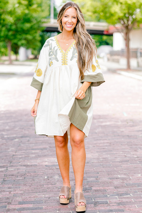 Chic Soul plus size clothing, white dress with half sleeves and olive accents on the ends of the sleeves and sides of the dress as well as a floral abstract pattern on the chest area and sleeves 