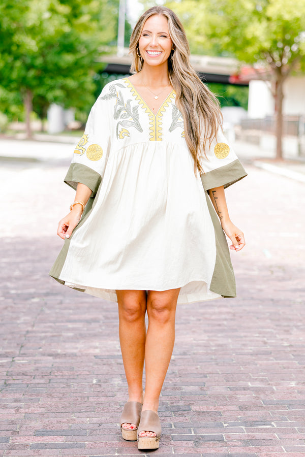 Chic Soul plus size clothing, white dress with half sleeves and olive accents on the ends of the sleeves and sides of the dress as well as a floral abstract pattern on the chest area and sleeves 