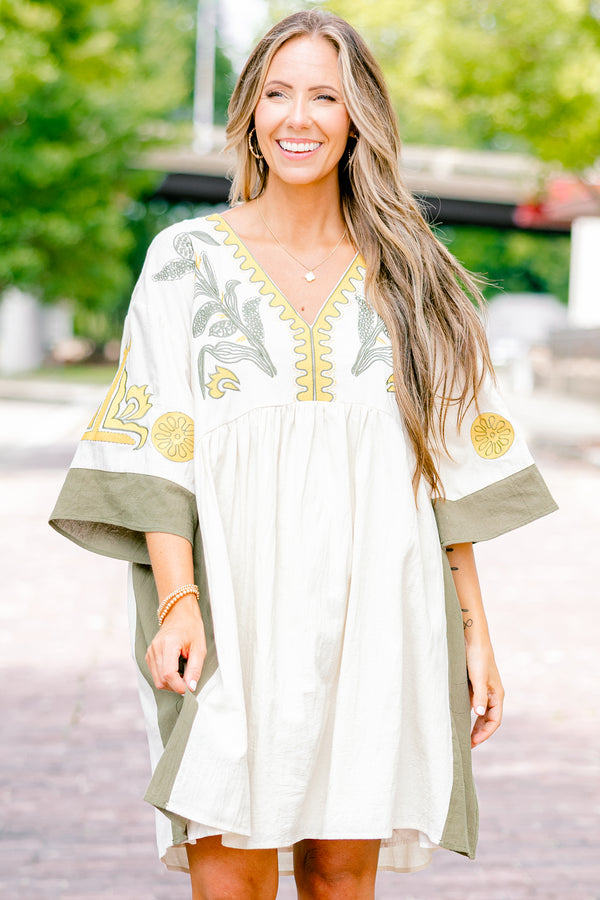 Chic Soul plus size clothing, white dress with half sleeves and olive accents on the ends of the sleeves and sides of the dress as well as a floral abstract pattern on the chest area and sleeves 