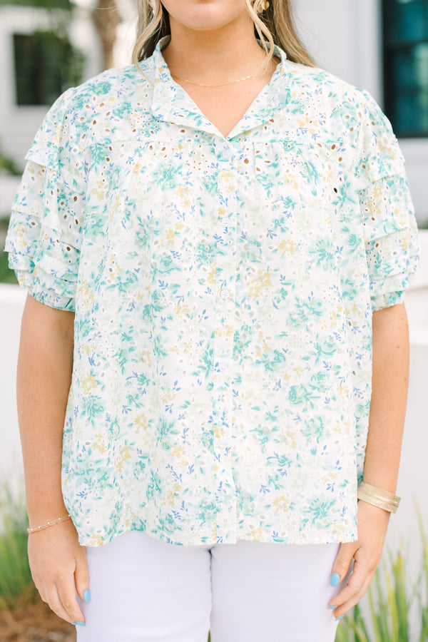Chic Soul plus size clothing, white top with short sleeves that have eyelet detailing on the sleeves as well as a multi-color floral pattern throughout the top and buttons going down the center of the shirt 
