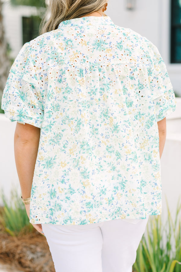 Chic Soul plus size clothing, white top with short sleeves that have eyelet detailing on the sleeves as well as a multi-color floral pattern throughout the top and buttons going down the center of the shirt 
