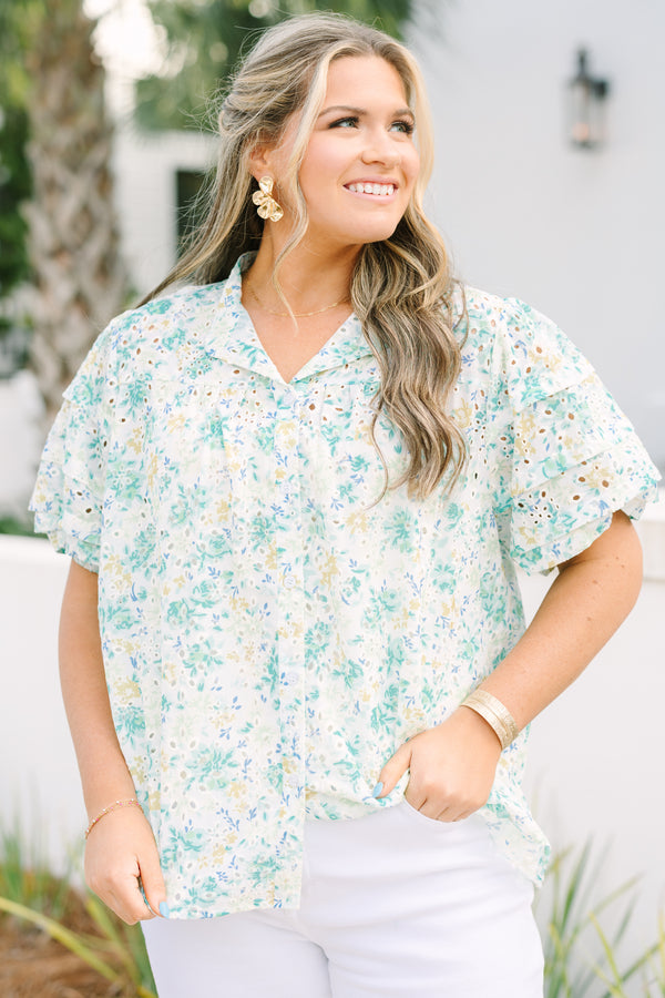 Chic Soul plus size clothing, white top with short sleeves that have eyelet detailing on the sleeves as well as a multi-color floral pattern throughout the top and buttons going down the center of the shirt 
