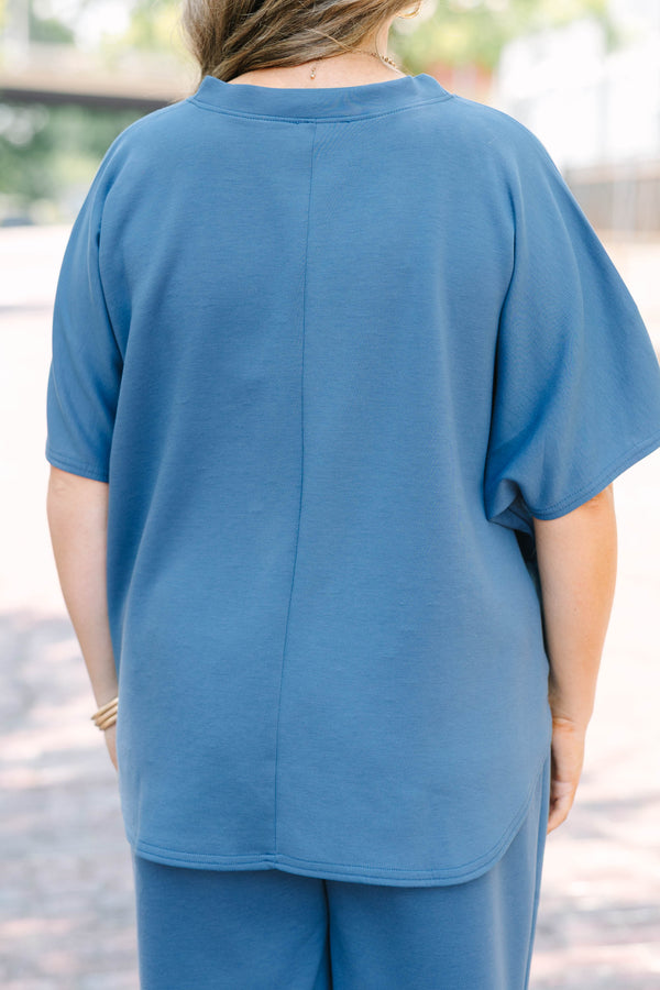 Plus Size dusty blue loungewear set with a short-sleeve curved hem top and matching wide-leg pants.