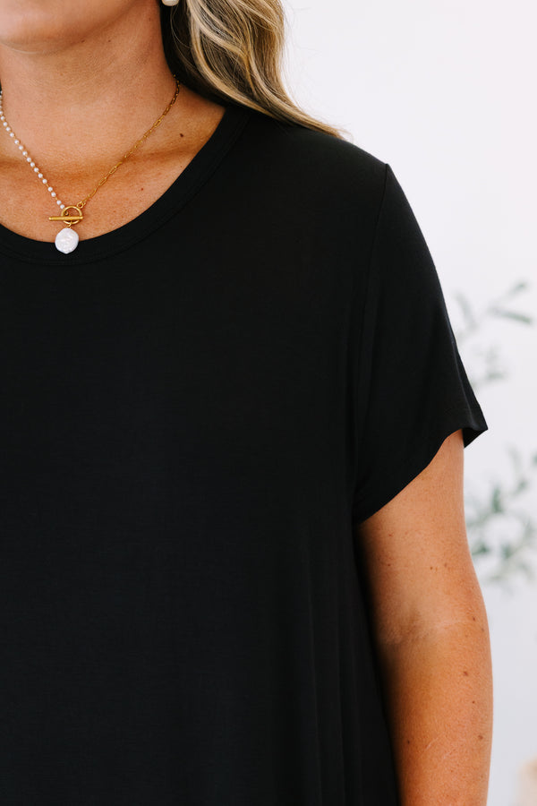 Plus Size short sleeve black crew neck dress with a relaxed fit and side pockets.