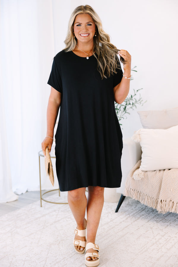 Plus Size short sleeve black crew neck dress with a relaxed fit and side pockets.