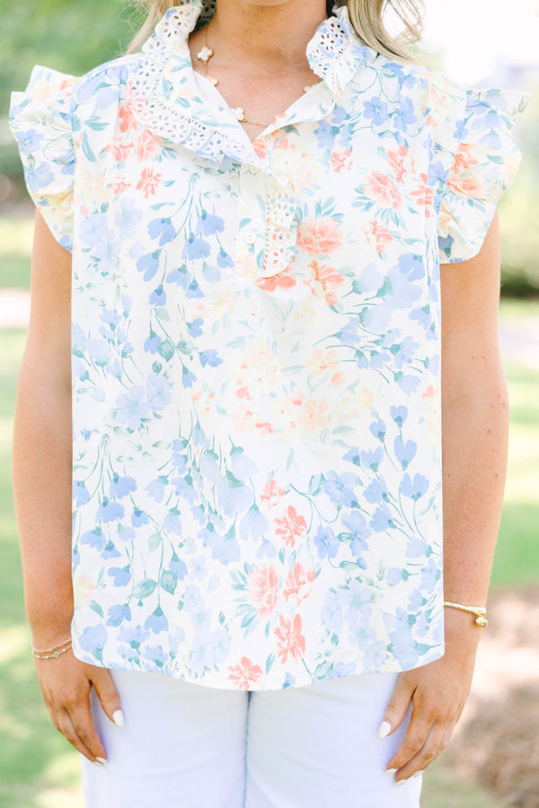 Plus Size white floral top with ruffle cap sleeves, a lace-trimmed collar, and white pants.