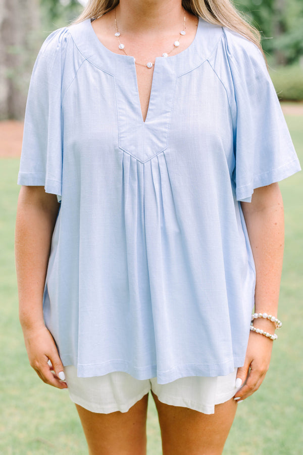 Plus Size light blue short sleeve top with a split neckline and pleated front detail.