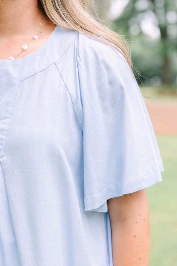 Plus Size light blue short sleeve top with a split neckline and pleated front detail.