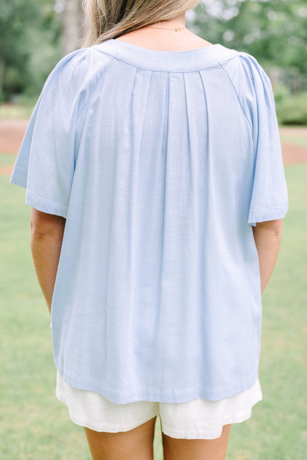 Plus Size light blue short sleeve top with a split neckline and pleated front detail.