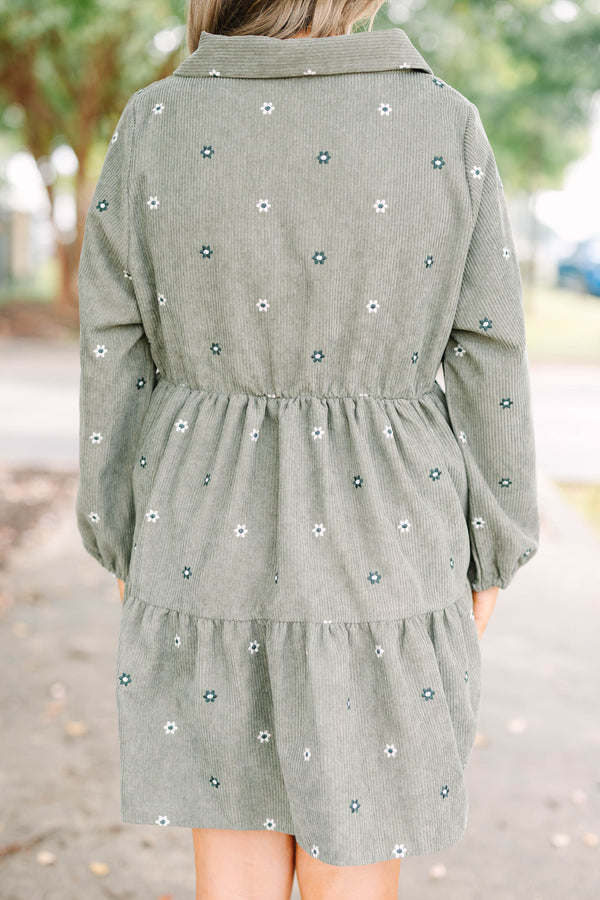 Plus size olive green corduroy babydoll dress with white floral embroidery and button-up front.