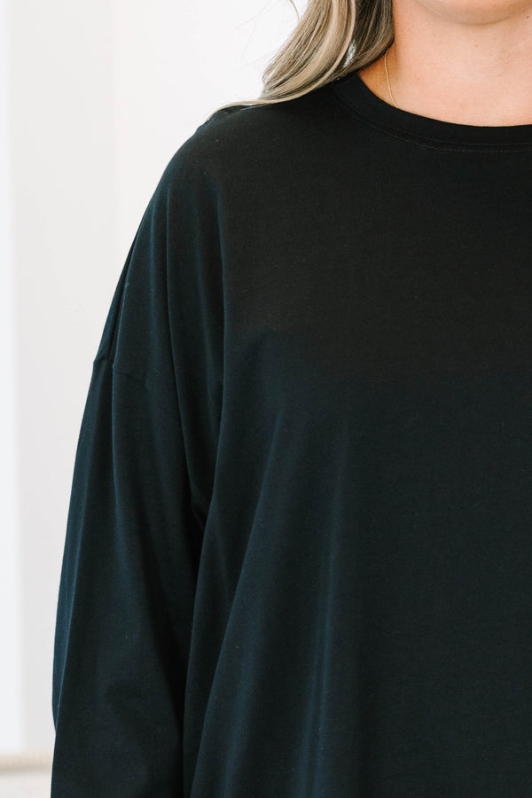 Plus Size black long sleeve top with a crew neckline and an asymmetrical lace hem.