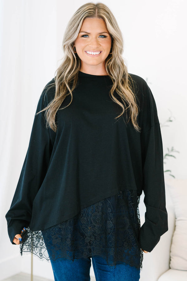 Plus Size black long sleeve top with a crew neckline and an asymmetrical lace hem.