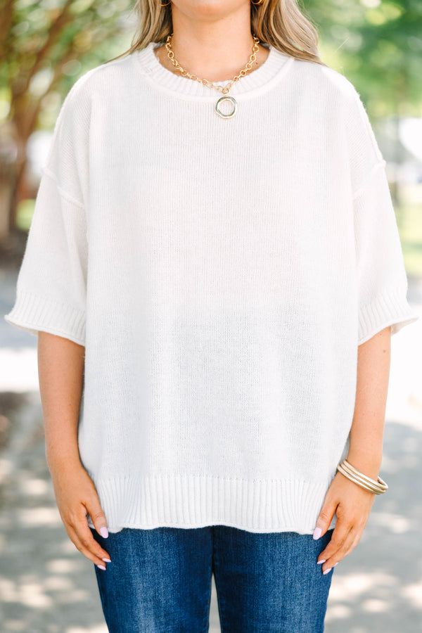 Plus size short-sleeve knit sweater top with a relaxed fit.