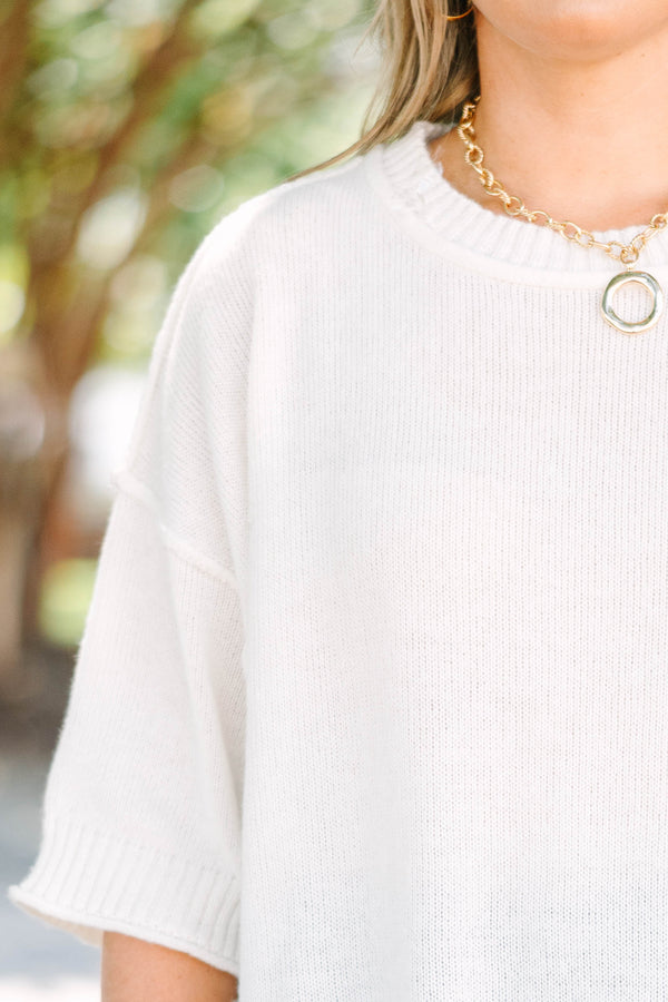 Plus size short-sleeve knit sweater top with a relaxed fit.