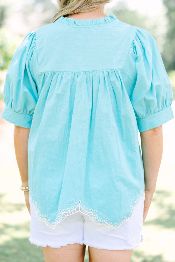 Plus Size turquoise cotton top with puff sleeves, a ruffled bodice, and white eyelet hem detailing.