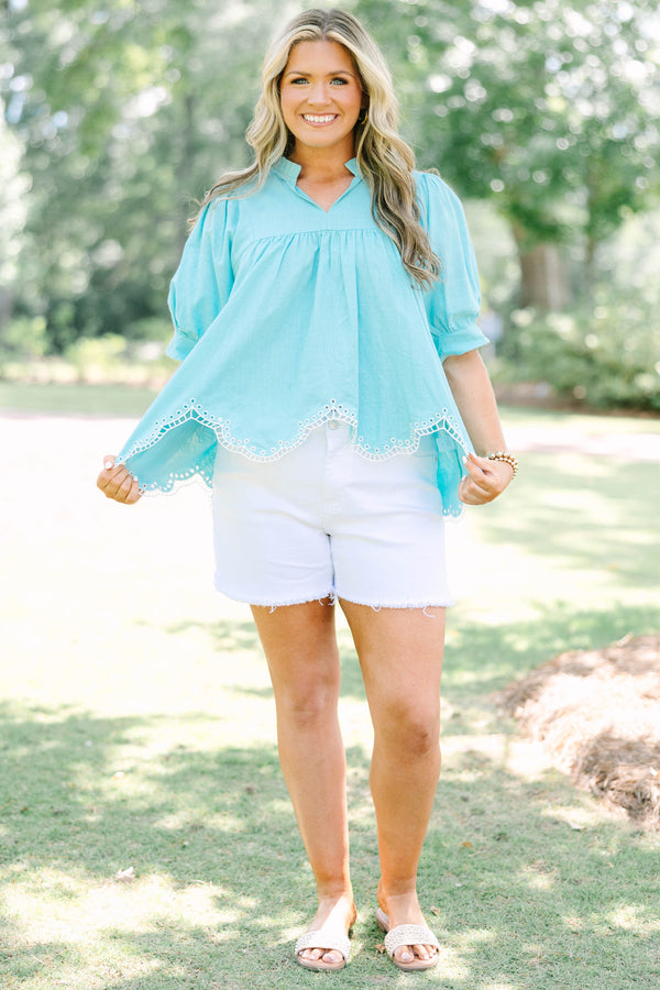Plus Size turquoise cotton top with puff sleeves, a ruffled bodice, and white eyelet hem detailing.