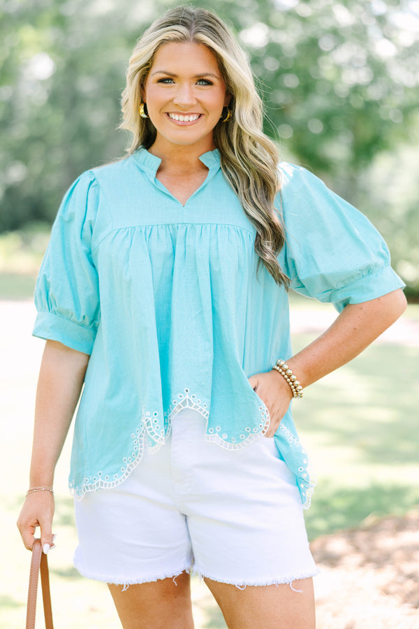 Plus Size turquoise cotton top with puff sleeves, a ruffled bodice, and white eyelet hem detailing.