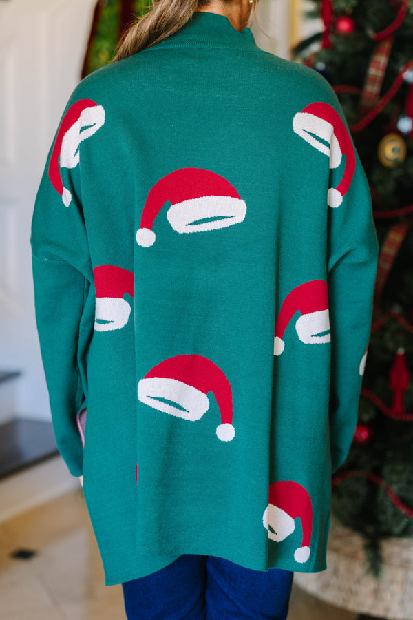 Plus Size green oversized tunic sweater with a mock neck and knit red and white Santa hat patterns.