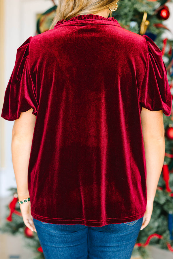 Plus size wine red velvet top with a V-neckline and flowy short sleeves for a festive holiday look.