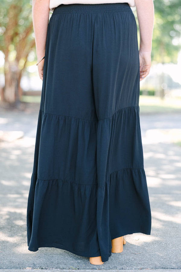 Plus Size black tiered wide-leg pants with a smocked waistband in a lightweight rayon fabric.