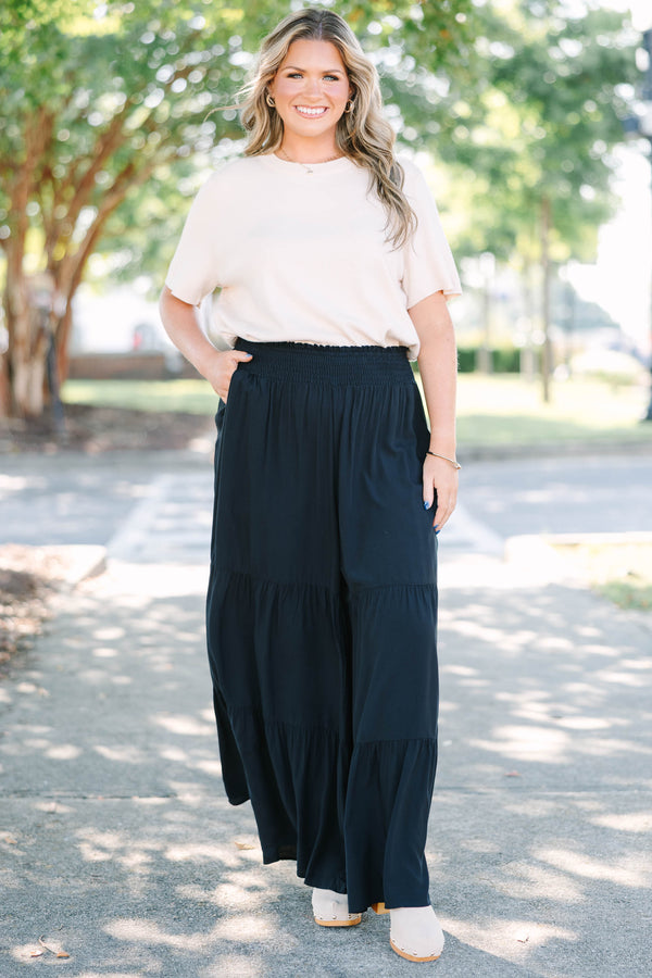 Plus Size black tiered wide-leg pants with a smocked waistband in a lightweight rayon fabric.