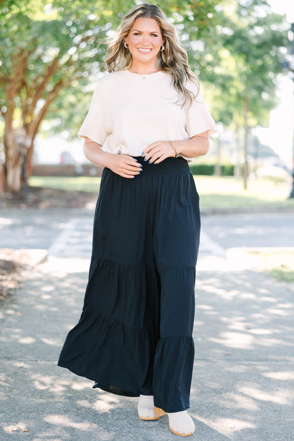 Plus Size black tiered wide-leg pants with a smocked waistband in a lightweight rayon fabric.