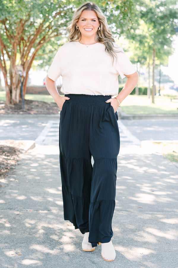 Plus Size black tiered wide-leg pants with a smocked waistband in a lightweight rayon fabric.