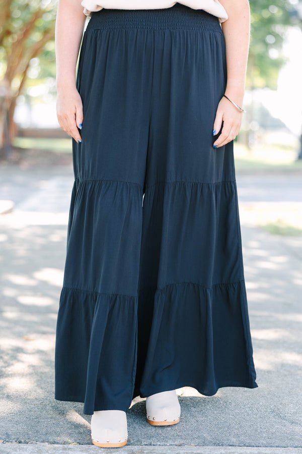 Plus Size black tiered wide-leg pants with a smocked waistband in a lightweight rayon fabric.