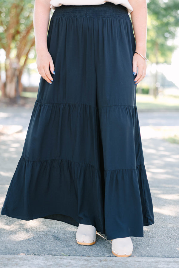 Plus Size black tiered wide-leg pants with a smocked waistband in a lightweight rayon fabric.