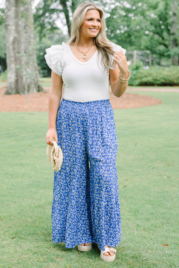 Plus Size blue floral wide-leg tiered pants with a smocked waistband and ditsy flower print.