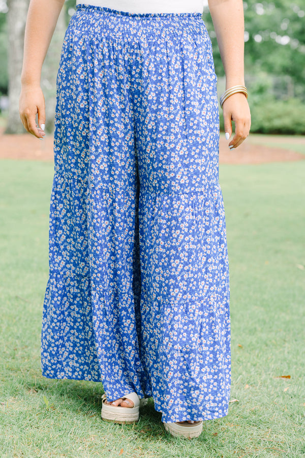 Plus Size blue floral wide-leg tiered pants with a smocked waistband and ditsy flower print.