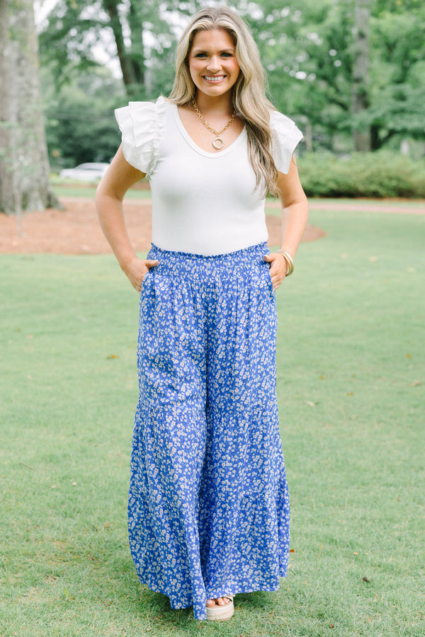 Plus Size blue floral wide-leg tiered pants with a smocked waistband and ditsy flower print.