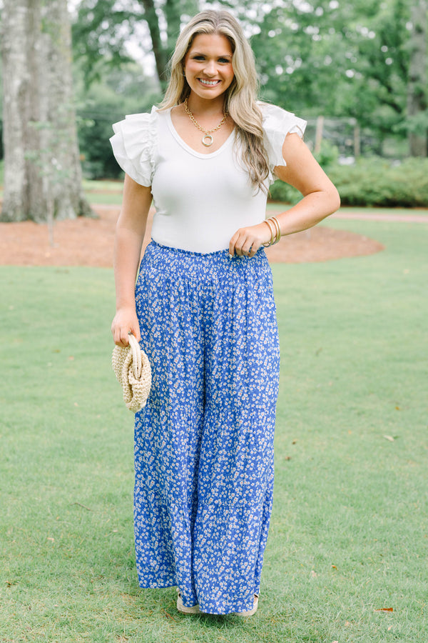 Plus Size blue floral wide-leg tiered pants with a smocked waistband and ditsy flower print.