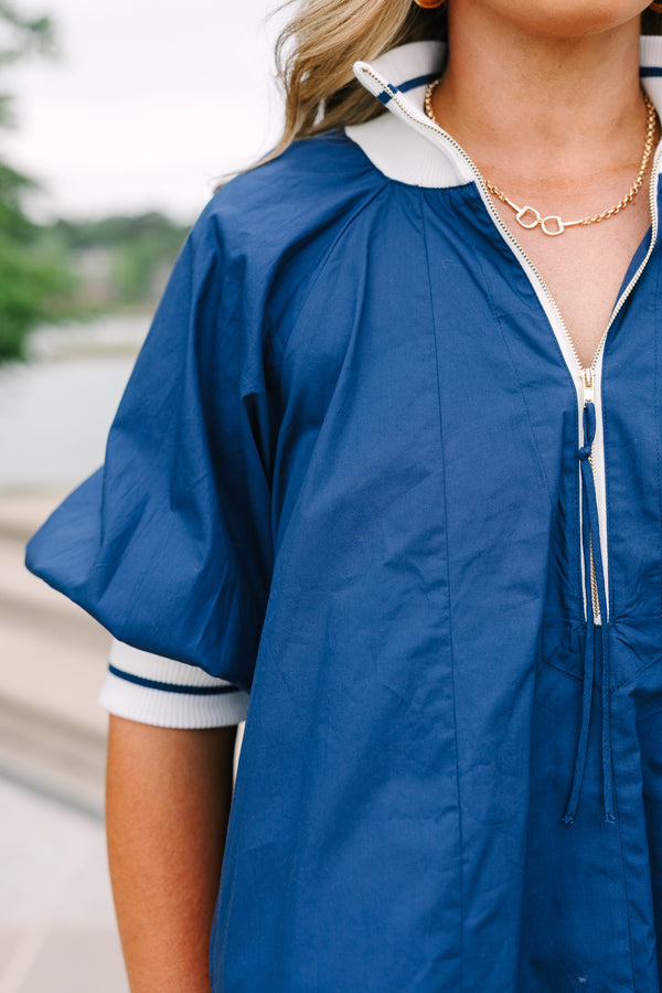 Plus Size navy blue quarter-zip top with white collar, puff sleeves, and white shorts.