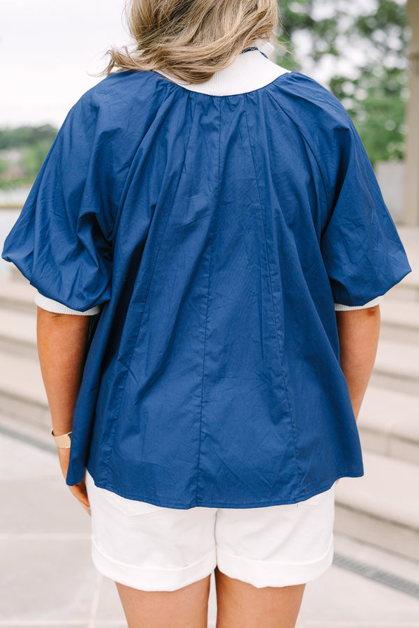 Plus Size navy blue quarter-zip top with white collar, puff sleeves, and white shorts.