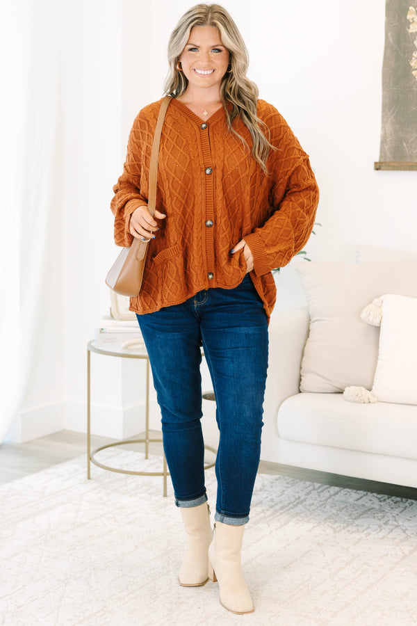 Plus Size brown cable knit cardigan with a V-neckline, button-front, and front pockets.