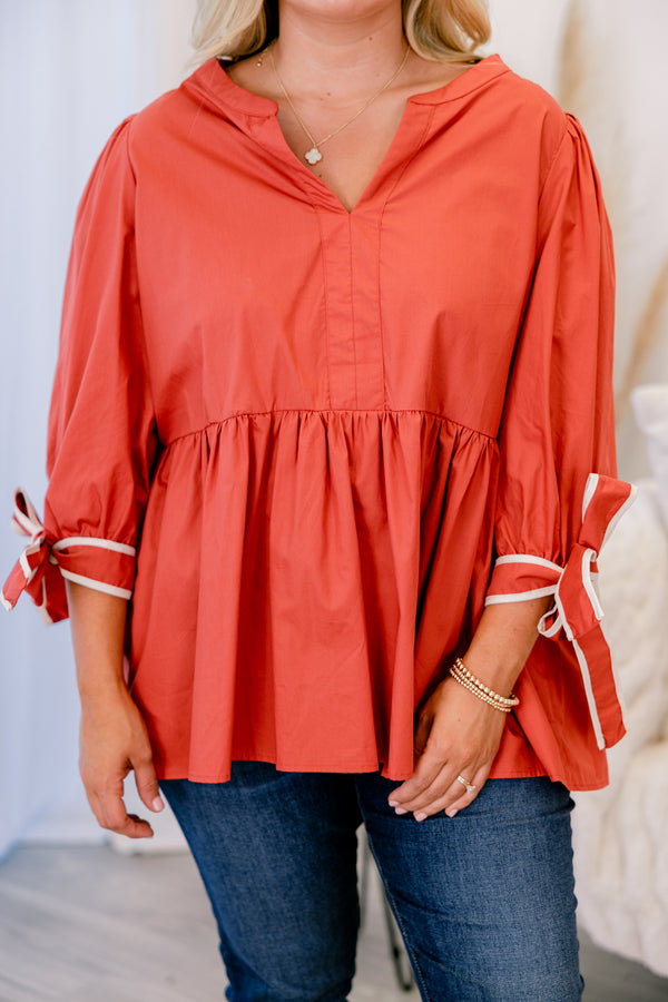Chic Soul plus size clothing, orange baby doll long sleeve top with a slight v-neckline and bows that tie at the end of each sleeve 