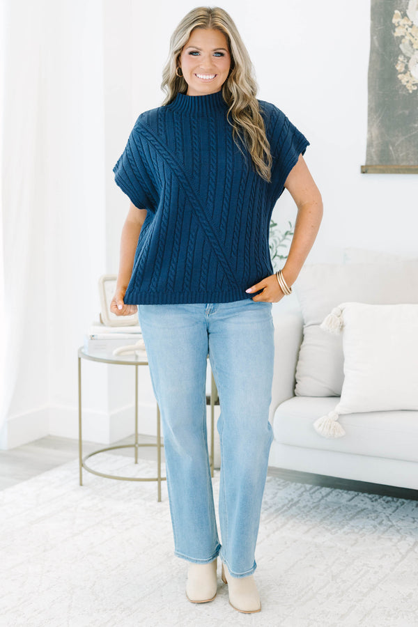 Plus size navy blue sleeveless cable-knit sweater with a mock neckline and diagonal seam detail.