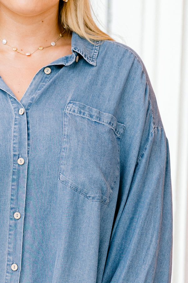 Chic Soul plus size clothing, denim long sleeve top with a pocket of the left side of the chest and a ruffle detail going along the bottom of the top 