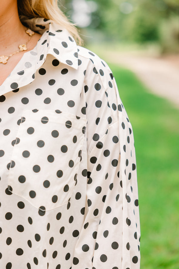 Chic Soul plus size clothing, cream long sleeve button up collared long sleeve blouse with black polka dots and a ruffle hem 
