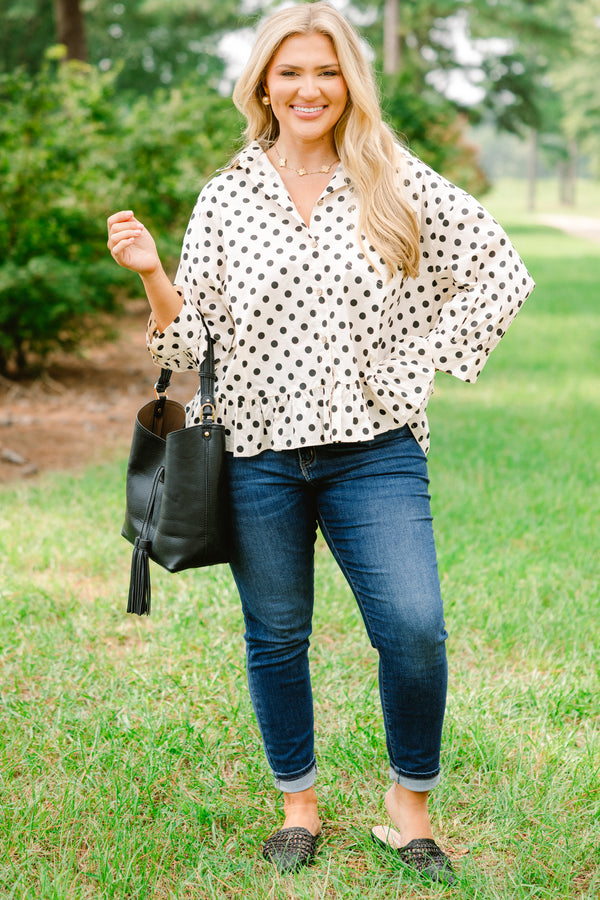 Chic Soul plus size clothing, cream long sleeve button up collared long sleeve blouse with black polka dots and a ruffle hem 
