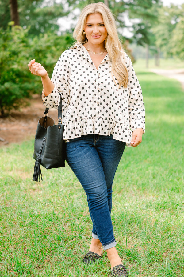 Chic Soul plus size clothing, cream long sleeve button up collared long sleeve blouse with black polka dots and a ruffle hem 

