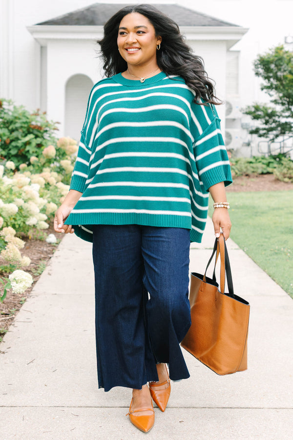 Plus size green and white striped, oversized knit sweater with a flowy, relaxed fit.