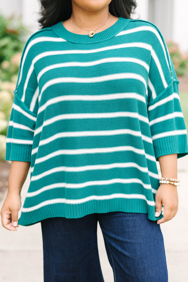 Plus size green and white striped, oversized knit sweater with a flowy, relaxed fit.