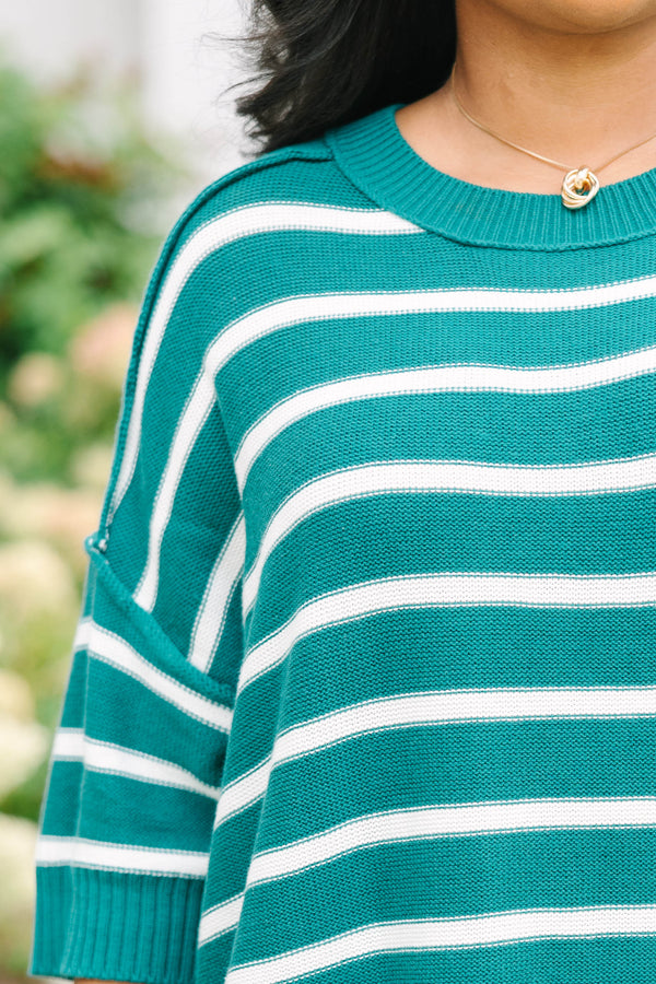 Plus size green and white striped, oversized knit sweater with a flowy, relaxed fit.