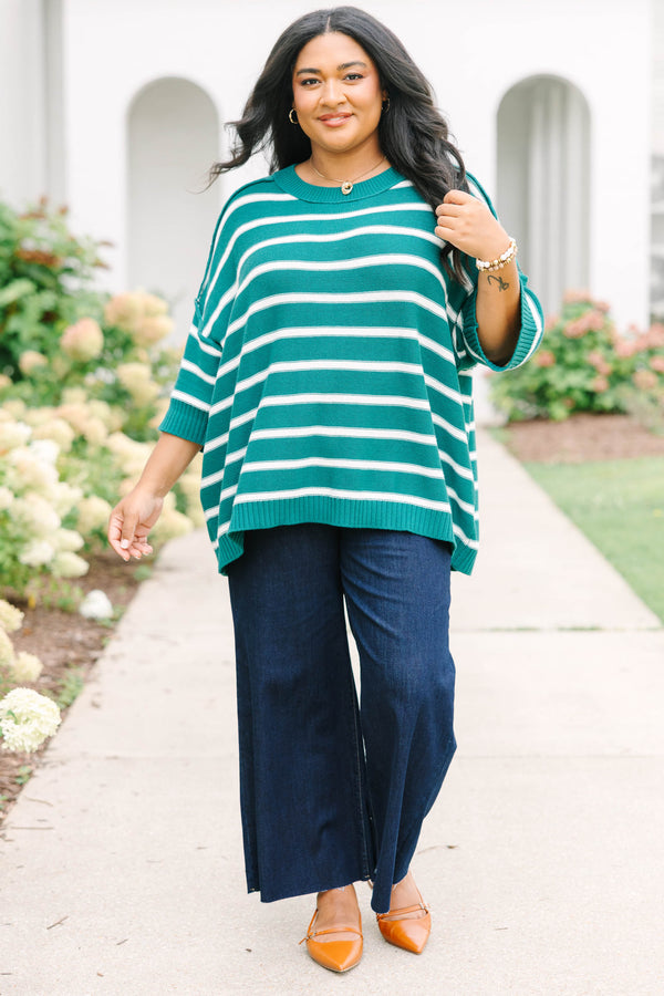 Plus size green and white striped, oversized knit sweater with a flowy, relaxed fit.