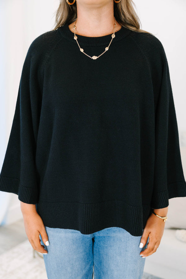 Plus Size black oversized knit sweater with a crew neckline and wide three-quarter length sleeves.