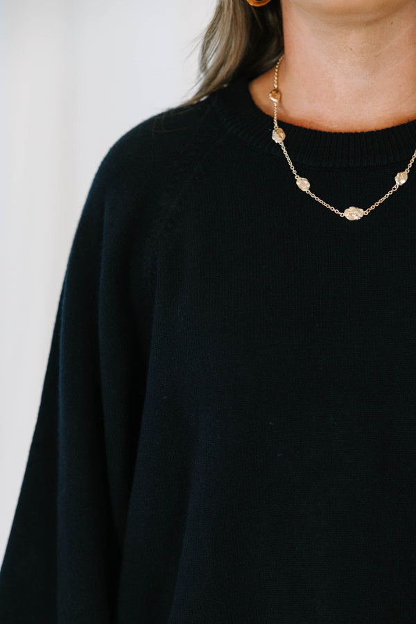 Plus Size black oversized knit sweater with a crew neckline and wide three-quarter length sleeves.